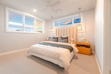 Beach style guest bedroom in Gold Coast - Tweed with beige walls, carpet and beige floor.