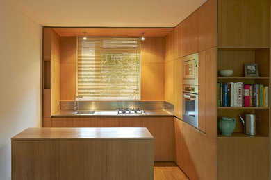 Contemporary open plan kitchen in London with with island.