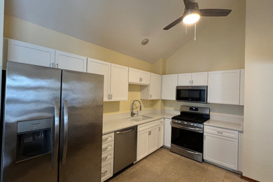 Inspiration for a mid-sized transitional l-shaped enclosed kitchen remodel in Chicago with shaker cabinets, white cabinets, quartz countertops and white countertops