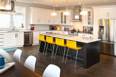 Inspiration for a large transitional l-shaped medium tone wood floor eat-in kitchen remodel in Other with an undermount sink, shaker cabinets, white cabinets, quartz countertops, stainless steel appliances and an island