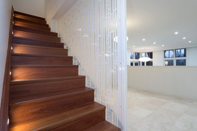Mid-sized traditional wood straight staircase in Canberra - Queanbeyan with wood risers.