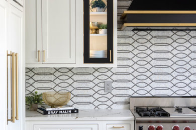 Open concept kitchen - huge traditional u-shaped medium tone wood floor and brown floor open concept kitchen idea in Philadelphia with an undermount sink, beaded inset cabinets, white cabinets, quartz countertops, multicolored backsplash, mosaic tile backsplash, paneled appliances, an island and white countertops