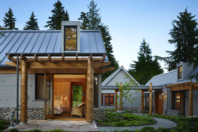 Mid-sized country one-storey exterior in Seattle with wood siding and a gable roof.
