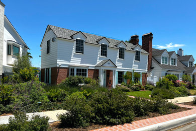 Traditional white two-story wood and clapboard exterior home idea in San Diego with a shingle roof and a black roof
