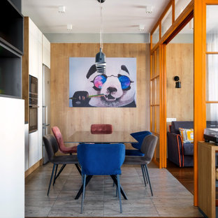 На фото: гостиная-столовая в стиле лофт с серыми стенами и серым полом с