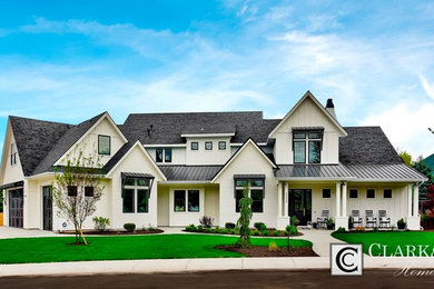 Inspiration for a large country white two-story mixed siding gable roof remodel in Boise