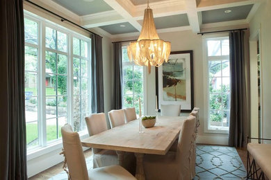Photo of a traditional separate dining room in Austin with beige walls and medium hardwood floors.