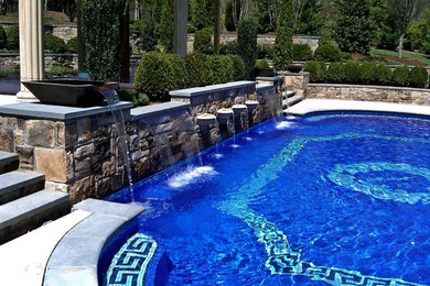 Inspiration for a large mediterranean backyard stone and custom-shaped aboveground pool house remodel in Miami