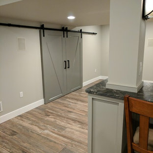 Medium sized classic look-out basement in Other with grey walls and porcelain flooring.