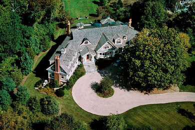 Large elegant gray two-story vinyl gable roof photo in Boston