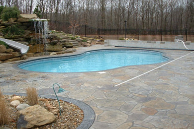 Inspiration for a mid-sized rustic backyard stone and custom-shaped water slide remodel in Other