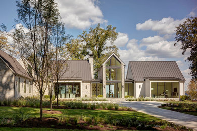 Imagen de fachada de casa gris y marrón moderna extra grande de dos plantas con revestimiento de piedra y tejado de metal