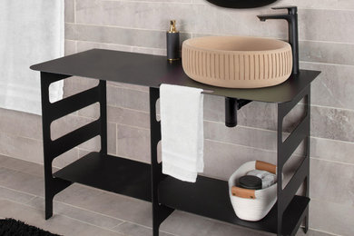 Bathroom - large contemporary master beige tile and cement tile single-sink bathroom idea in Chicago with black cabinets, a vessel sink, stainless steel countertops, black countertops and a freestanding vanity