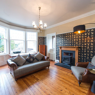 Design ideas for a medium sized modern study in Other with brown walls, a wood burning stove, a stone fireplace surround and a freestanding desk.