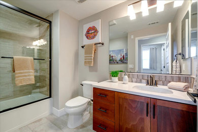 Bathroom - small transitional multicolored tile porcelain tile, beige floor and single-sink bathroom idea in San Francisco with a built-in vanity, shaker cabinets, medium tone wood cabinets, a two-piece toilet, beige walls, an undermount sink, quartzite countertops and beige countertops