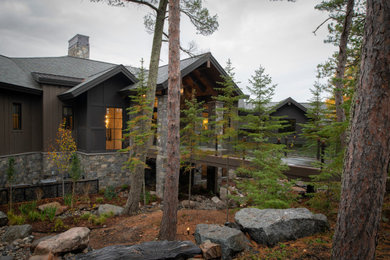 Huge rustic stone exterior home idea in Minneapolis