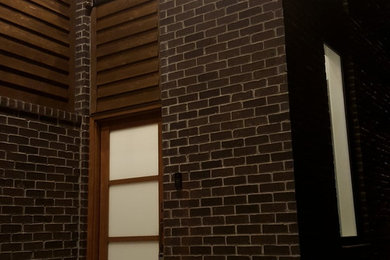 Example of a mid-sized minimalist brown two-story mixed siding flat roof design in Nashville