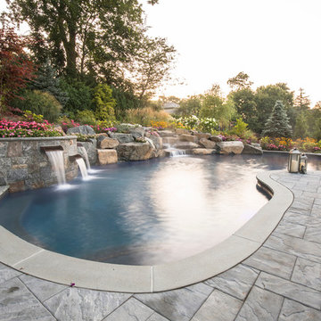 sunset over our custom pool with waterfalls