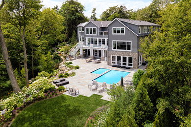 Photo of a large traditional full sun backyard concrete paver landscaping in Chicago for summer.