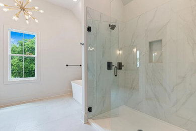 Bathroom - large farmhouse master white tile and porcelain tile porcelain tile, white floor, double-sink and vaulted ceiling bathroom idea in Nashville with shaker cabinets, light wood cabinets, a two-piece toilet, white walls, an undermount sink, quartz countertops, a hinged shower door, white countertops and a freestanding vanity