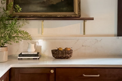 Inspiration for a mid-sized transitional galley medium tone wood floor and brown floor enclosed kitchen remodel in Portland with dark wood cabinets, quartz countertops, quartz backsplash, stainless steel appliances and no island