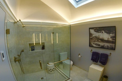 Bathroom - large transitional master gray tile and ceramic tile ceramic tile and gray floor bathroom idea in New York with furniture-like cabinets, dark wood cabinets, a two-piece toilet, gray walls, an undermount sink, granite countertops, a hinged shower door and black countertops