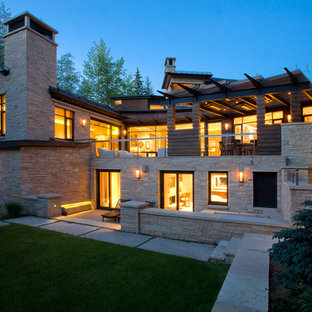Inspiration for a large modern two-story stone exterior home remodel in Denver with a shingle roof