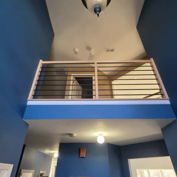 Modern Horizontal Stair Railing with Black Metal Bars and Red Oak T-Rail