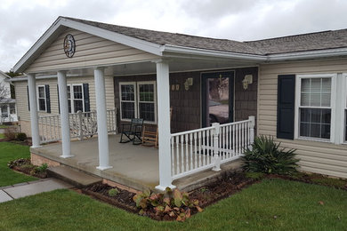 Inspiration for a mid-sized timeless concrete screened-in front porch remodel in Other with a roof extension