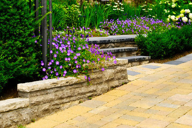 Photo of a large partial sun side yard concrete paver landscaping in Vancouver.