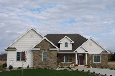 Mid-sized transitional beige one-story mixed siding exterior home idea in Other with a hip roof