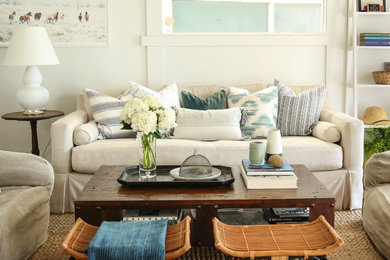 Example of a mid-sized beach style open concept laminate floor and gray floor living room design in Los Angeles with white walls, no fireplace and a wall-mounted tv