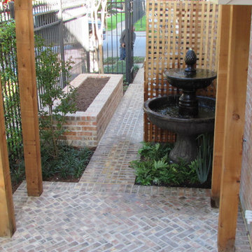 High function in a small side yard! Pergola, raised bed, mirrored wall, fountain