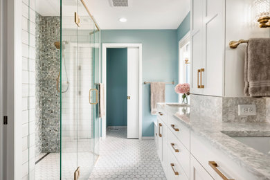 Inspiration for a mid-sized transitional master multicolored tile and ceramic tile ceramic tile, white floor and double-sink bathroom remodel in Minneapolis with recessed-panel cabinets, white cabinets, blue walls, an undermount sink, quartz countertops, a hinged shower door, beige countertops and a freestanding vanity