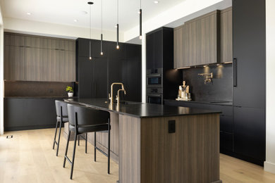 Eat-in kitchen - 1960s l-shaped eat-in kitchen idea in Vancouver with flat-panel cabinets and an island