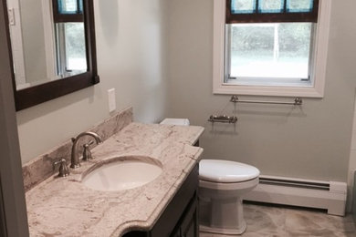 Bathroom - mid-sized traditional master multicolored tile and porcelain tile porcelain tile and gray floor bathroom idea in Bridgeport with raised-panel cabinets, dark wood cabinets, a two-piece toilet, gray walls, an undermount sink and granite countertops