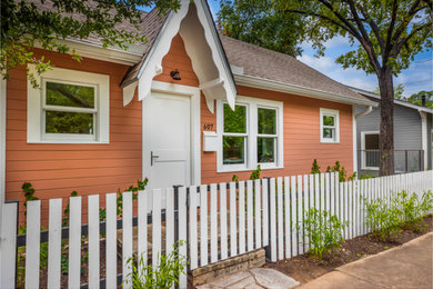 Inspiration for a small transitional orange one-story wood and clapboard exterior home remodel in Austin with a shingle roof and a brown roof