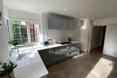 Photo of a small classic l-shaped enclosed kitchen in Hampshire with a single-bowl sink, shaker cabinets, grey cabinets, quartz worktops, no island and white worktops.