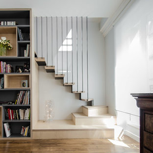 Medium sized contemporary wood l-shaped staircase in Paris with metal risers.