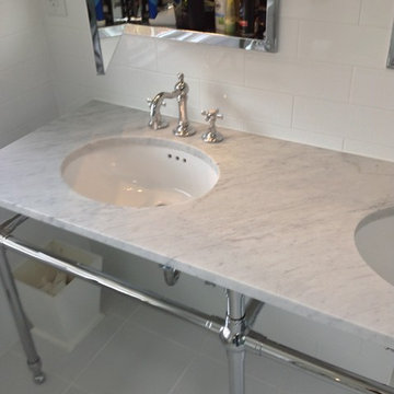 Marble vanity top and chrome mirrored medicine cabinet and sink plumbing fixture