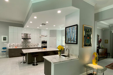Huge trendy u-shaped terrazzo floor and white floor open concept kitchen photo in Houston with an undermount sink, flat-panel cabinets, white cabinets, quartz countertops, multicolored backsplash, glass tile backsplash, paneled appliances, an island and gray countertops