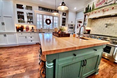 Inspiration for a large u-shaped eat-in kitchen in Raleigh with a farmhouse sink, shaker cabinets, white cabinets, granite benchtops, beige splashback, ceramic splashback, white appliances, medium hardwood floors, with island, brown floor and grey benchtop.