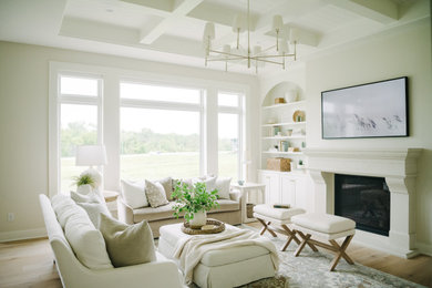 This is an example of a medium sized traditional open plan living room in Other with beige walls, light hardwood flooring, a standard fireplace, a stone fireplace surround, a wall mounted tv, beige floors and a coffered ceiling.