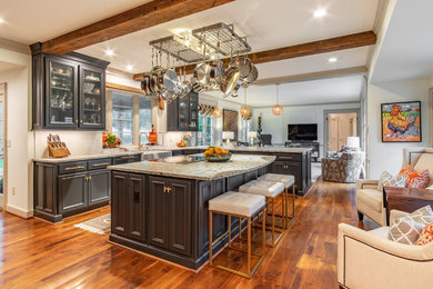 This is an example of an expansive traditional kitchen in Kansas City with a farmhouse sink, recessed-panel cabinets, blue cabinets, granite benchtops, white splashback, stainless steel appliances, medium hardwood floors, with island and brown floor.