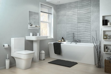 Example of a mid-sized minimalist 3/4 light wood floor, beige floor and single-sink freestanding bathtub design in Los Angeles with a one-piece toilet, gray walls and a pedestal sink