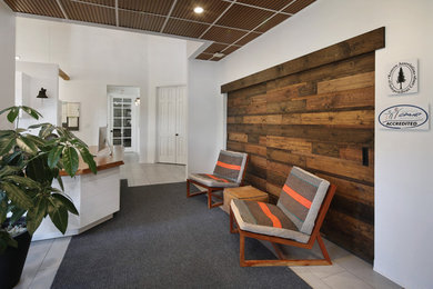 Foyer - rustic porcelain tile and gray floor foyer idea in Orange County with white walls