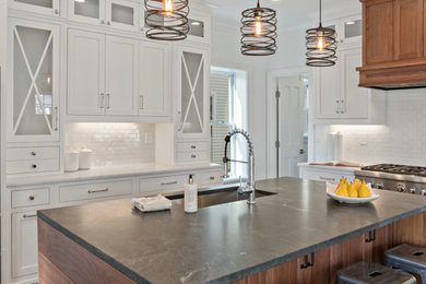 Eat-in kitchen - transitional u-shaped eat-in kitchen idea in Other with an island