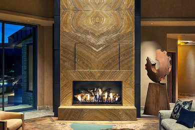 Example of a huge trendy open concept limestone floor living room design in Phoenix with beige walls, a standard fireplace, a stone fireplace and a wall-mounted tv