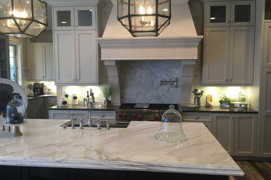 Eat-in kitchen - large cottage medium tone wood floor eat-in kitchen idea in Denver with a farmhouse sink, shaker cabinets, gray cabinets, marble countertops, gray backsplash, mosaic tile backsplash, paneled appliances and an island