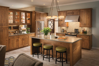 Arts and crafts l-shaped open concept kitchen photo in DC Metro with an undermount sink, shaker cabinets, medium tone wood cabinets, quartzite countertops, beige backsplash, mosaic tile backsplash and stainless steel appliances